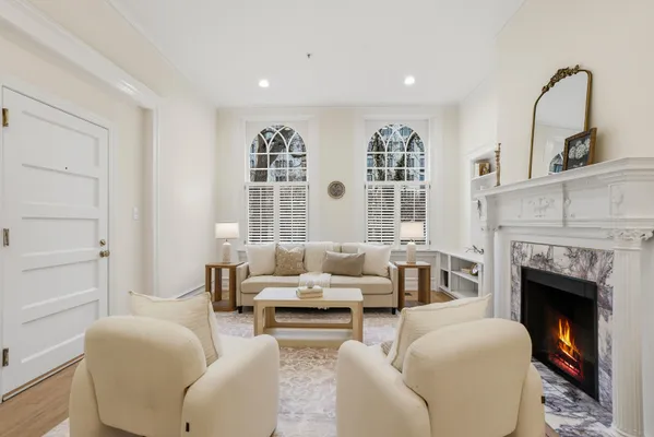 a living room with furniture and a fireplace