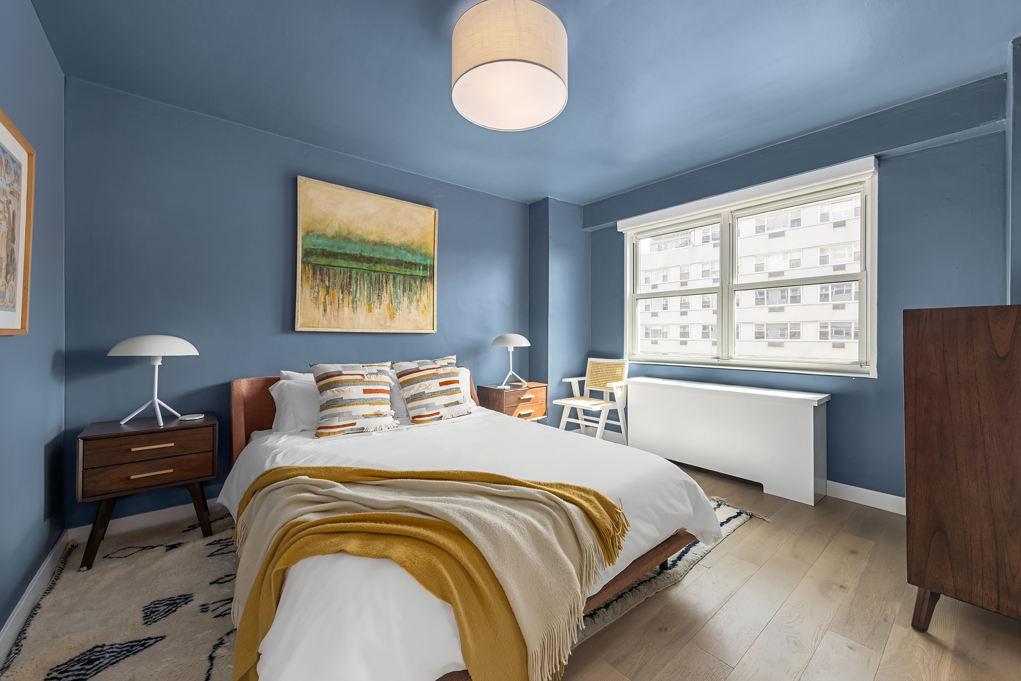 101 West 12th Street, Unit 12R Manhattan, NY 10011 - Photo 15 of 21 a bedroom with a bed and a window