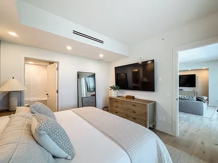 a bedroom with two beds and a night stand