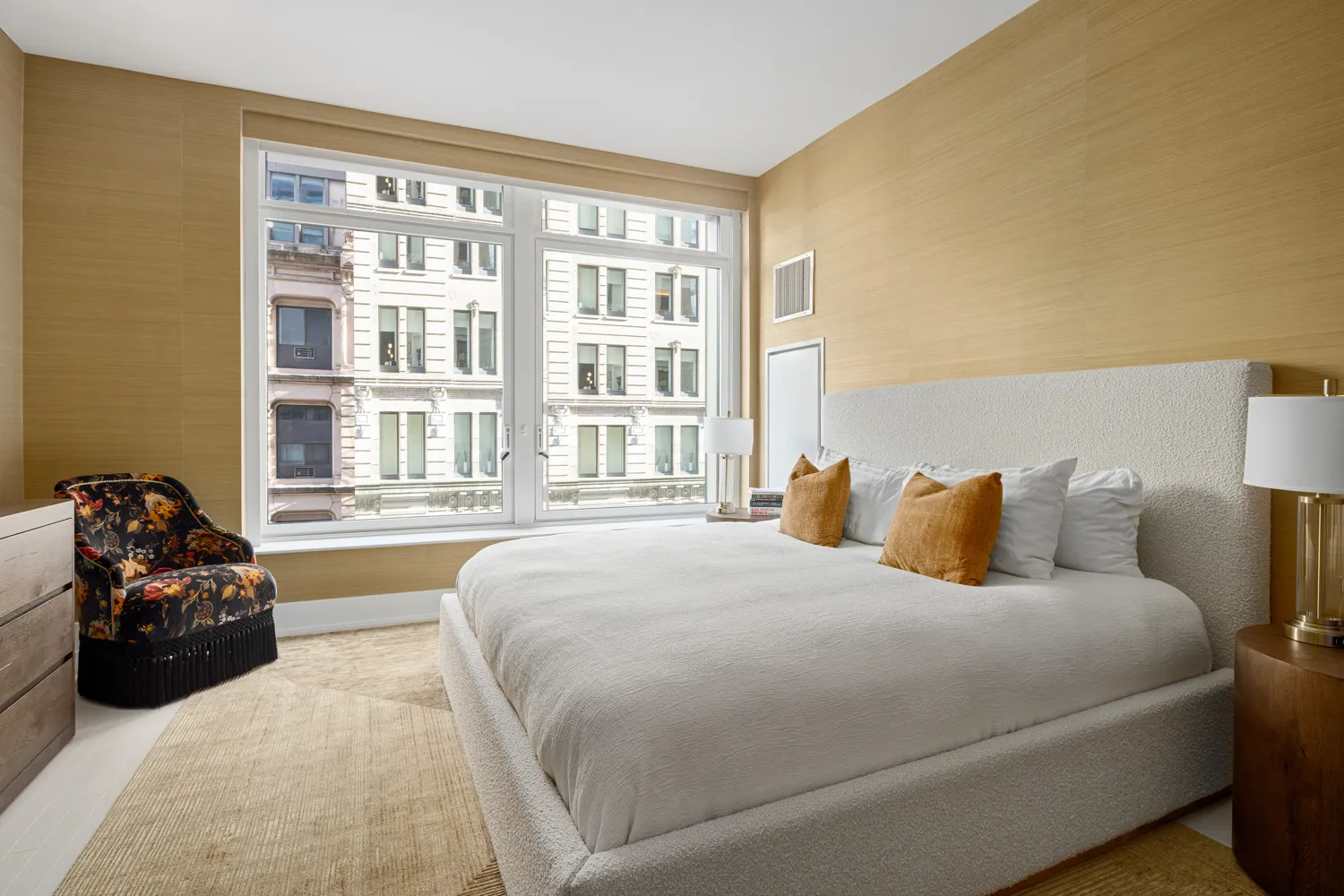 a bedroom with a bed and a large window