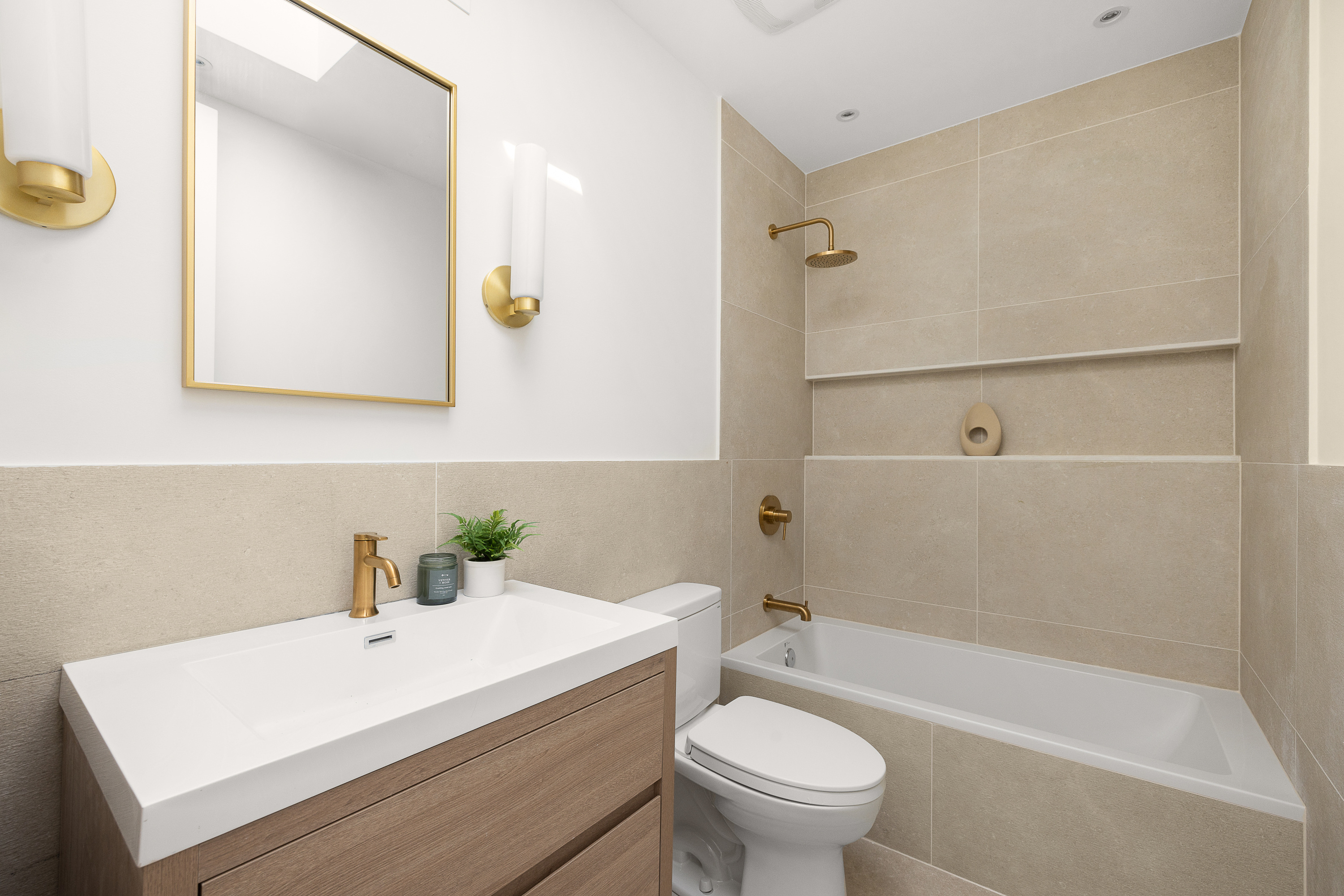 809 Lincoln Place Brooklyn, NY 11216 - Photo 13 of 20 a bathroom with a sink a toilet and a bathtub