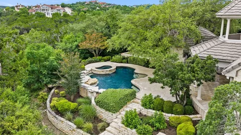 a view of a house with pool fire pit a yard and swimming pool