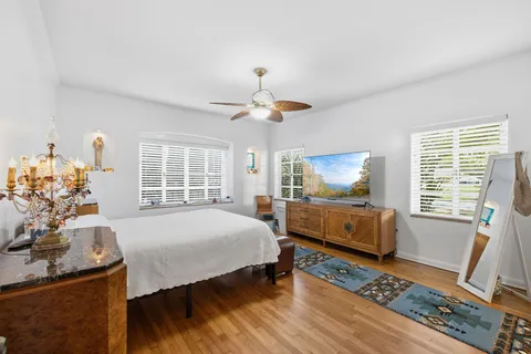 a bedroom with a bed and wooden floor