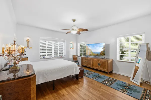 a bedroom with a bed and wooden floor