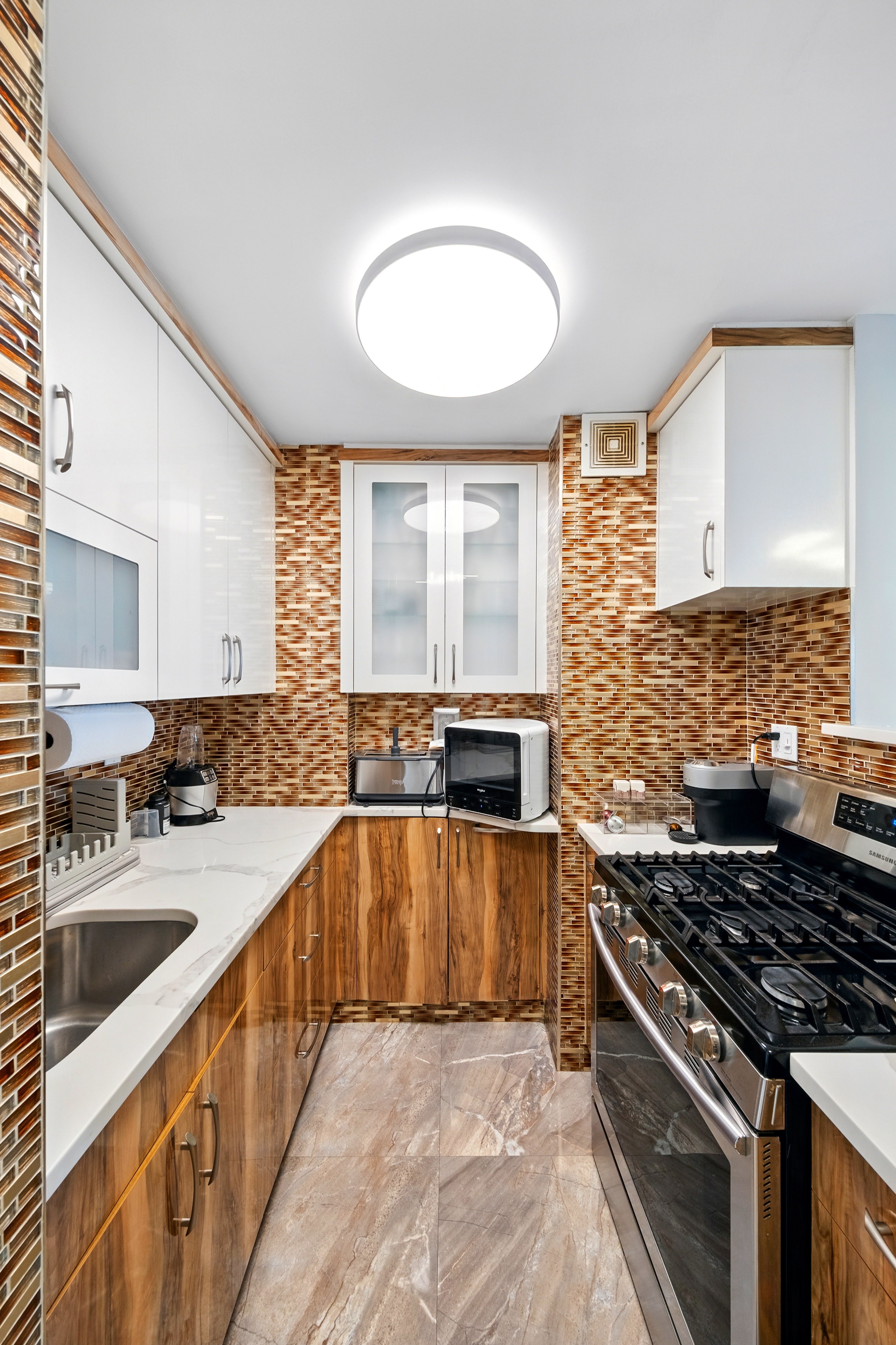 1360 Ocean Parkway, Unit 7B Brooklyn, NY 11230 - Photo 4 of 14 a kitchen with stainless steel appliances granite countertop a sink stove and cabinets