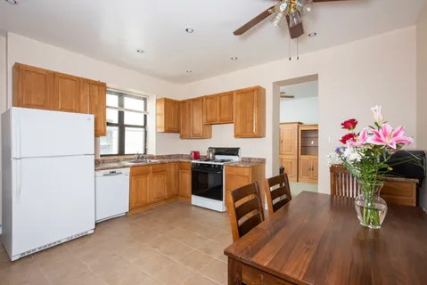 a bedroom with a bed and a dresser next to a window