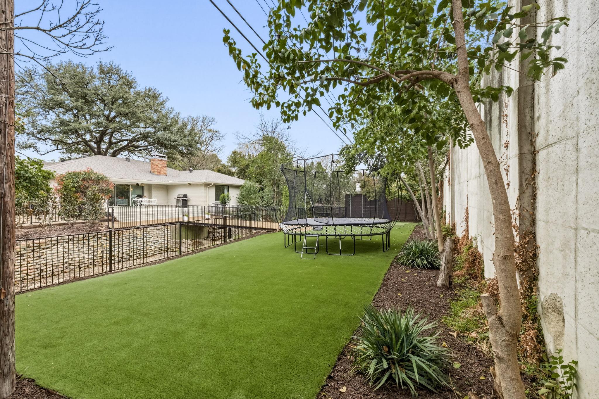 5765 Stonegate Road Dallas, TX 75209 - Photo 35 of 37 a view of house with swimming pool and sitting area
