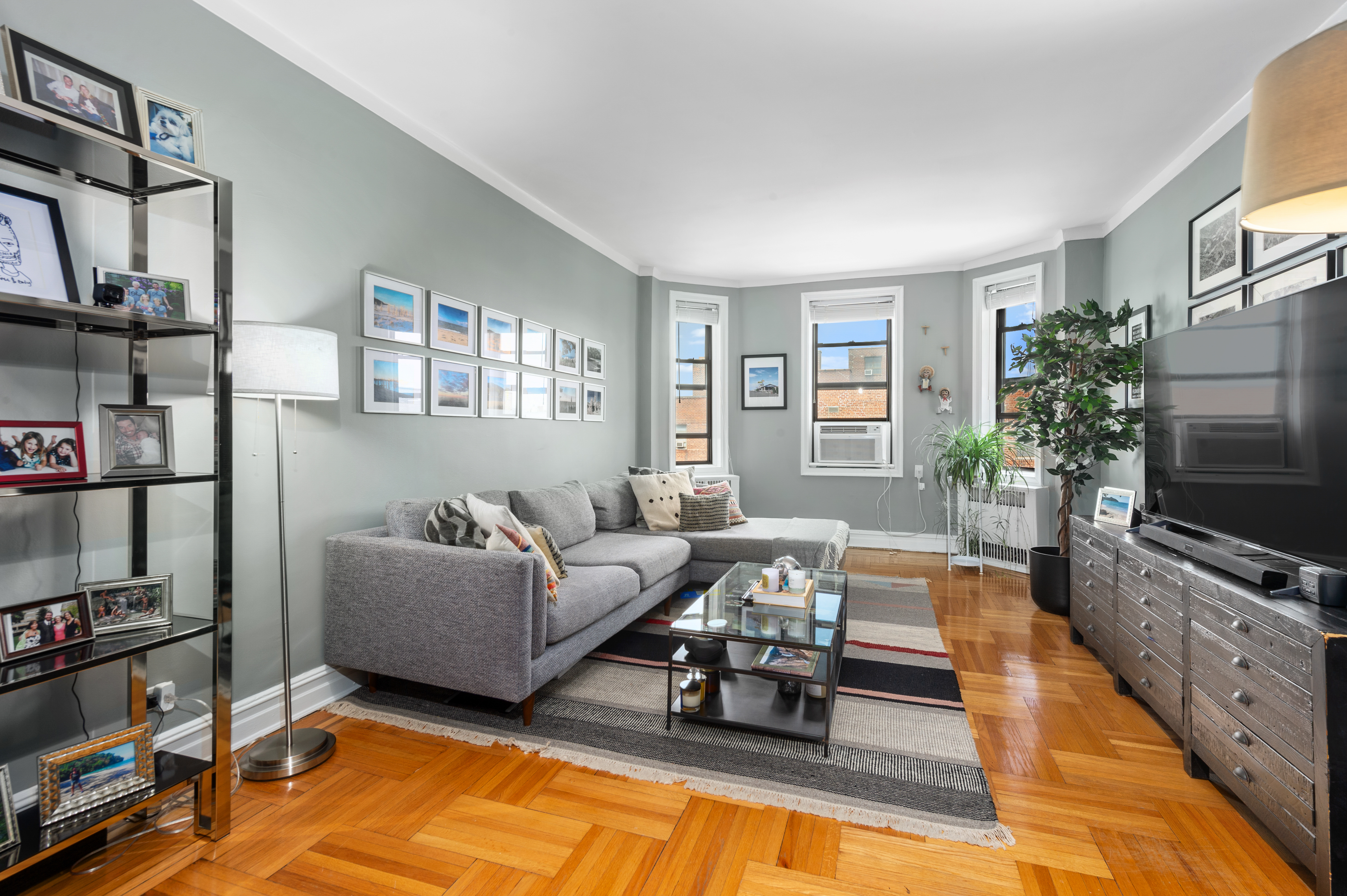 35-06 88th Street, Unit 6B Queens, NY 11372 - Photo 1 of 9 a living room with furniture and a flat screen tv