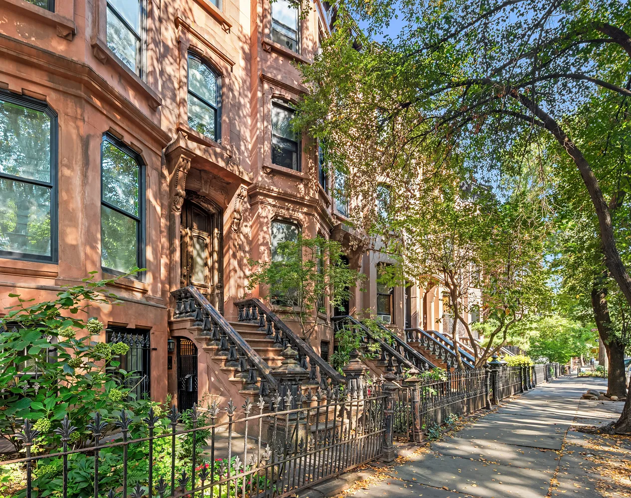 a front view of a house with a tree