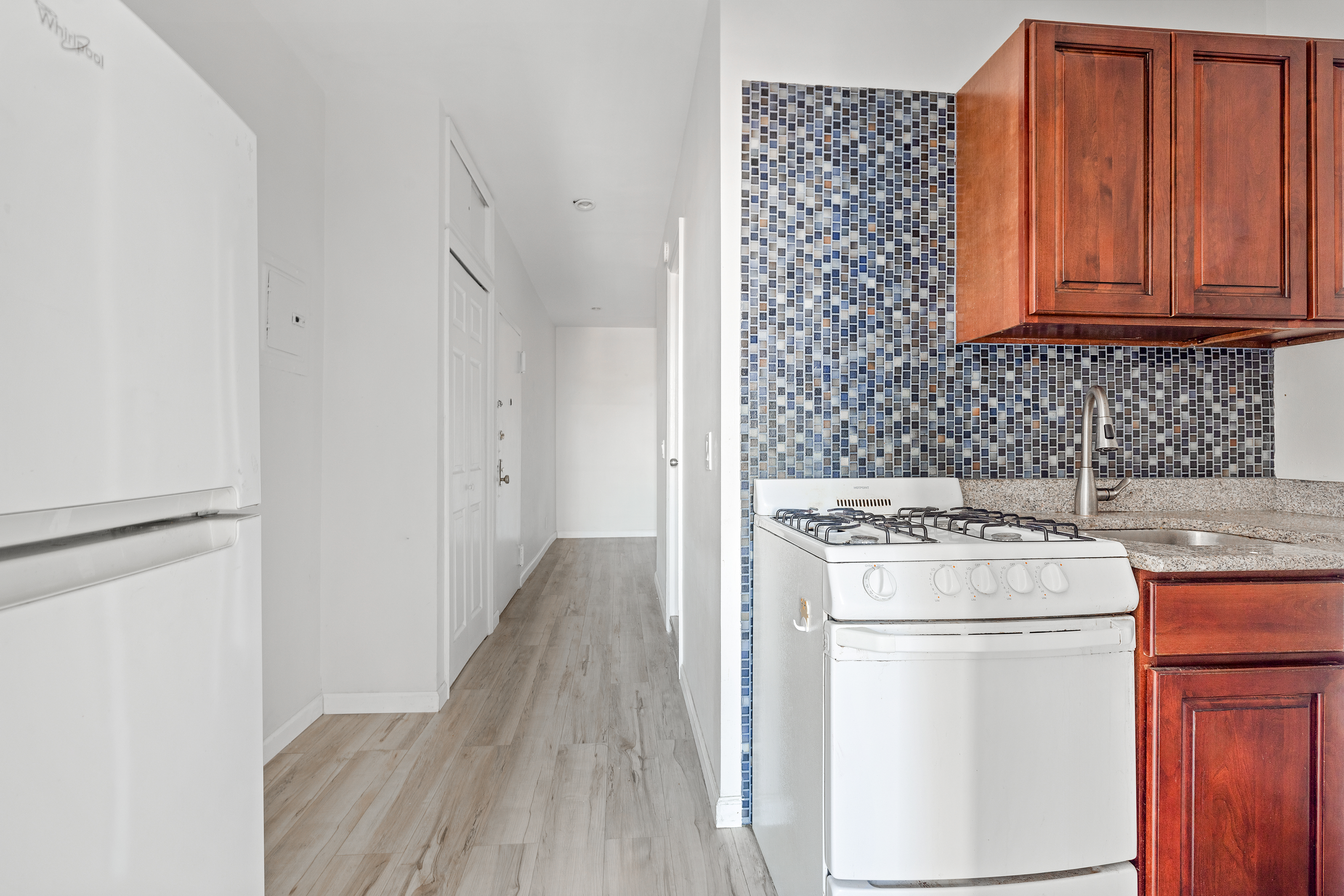 117 Henry Street, Unit 12A Manhattan, NY 10002 - Photo 2 of 5 a utility room with dryer and washer
