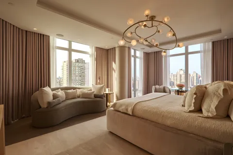 a bedroom with furniture and a large window