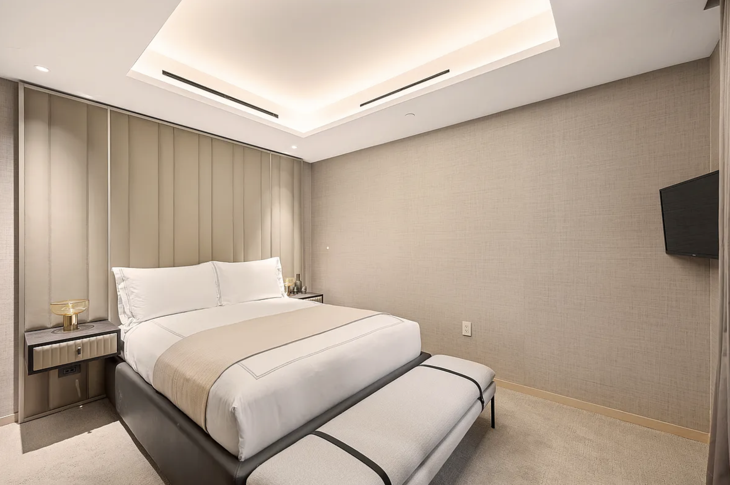 685 5th Avenue, Unit 6B Manhattan, NY 10022 - Photo 5 of 18 a bedroom with a bed and a flat screen tv