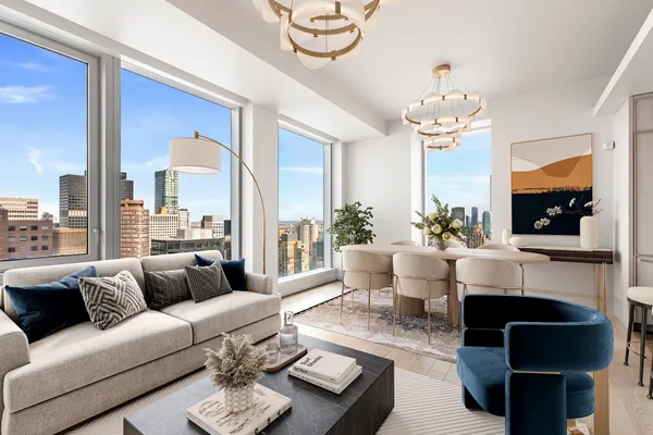 a living room with furniture a chandelier and a flat screen tv