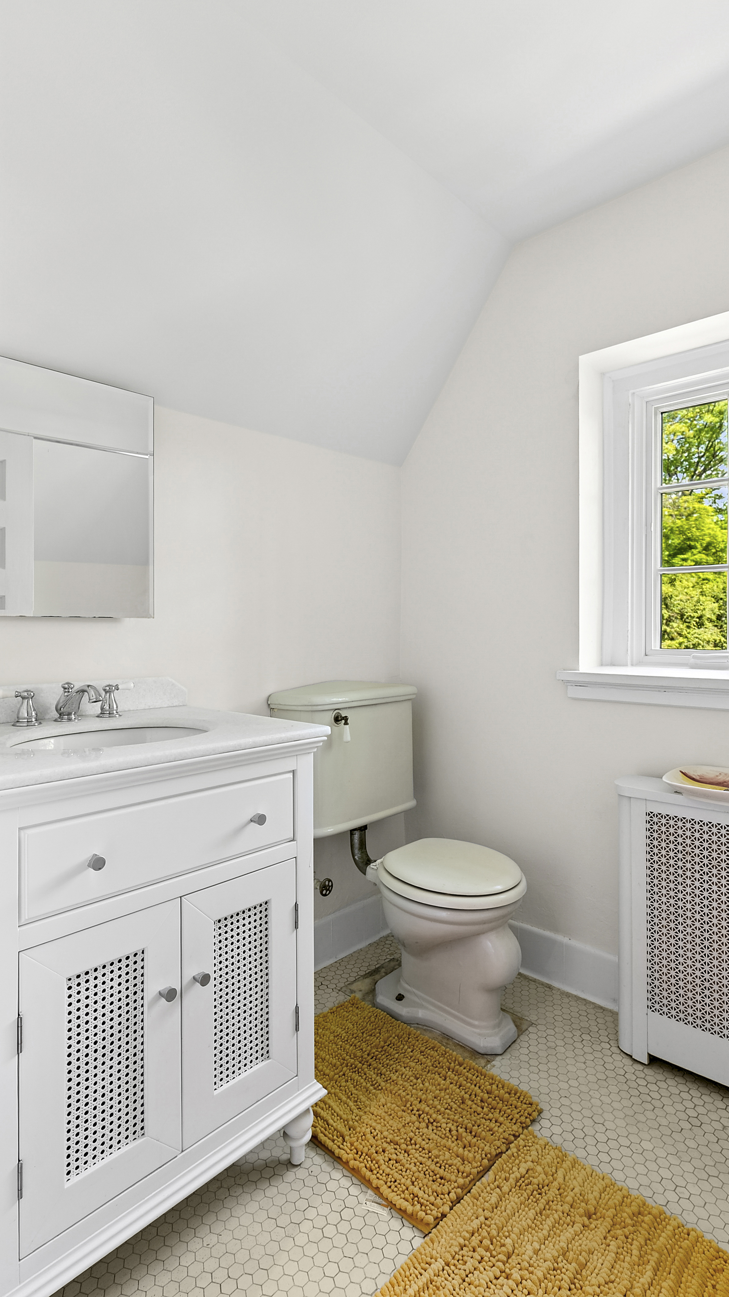 4417 Tibbett Avenue Bronx, NY 10471 - Photo 18 of 20 a bathroom with a toilet a sink a vanity and mirror
