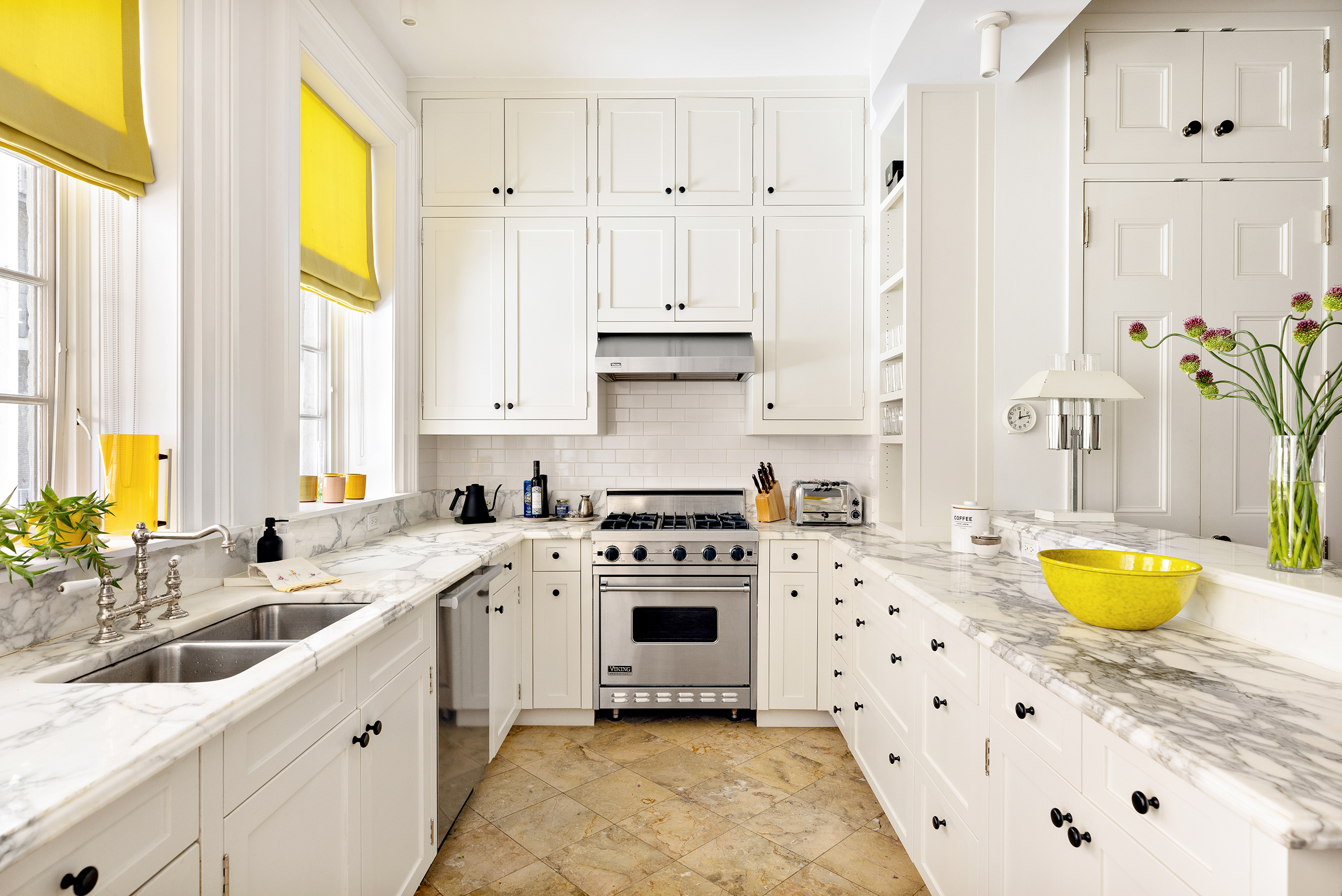 9 West 16th Street, Unit 3 Manhattan, NY 10011 - Photo 5 of 16 a kitchen with stainless steel appliances a white cabinets and a sink