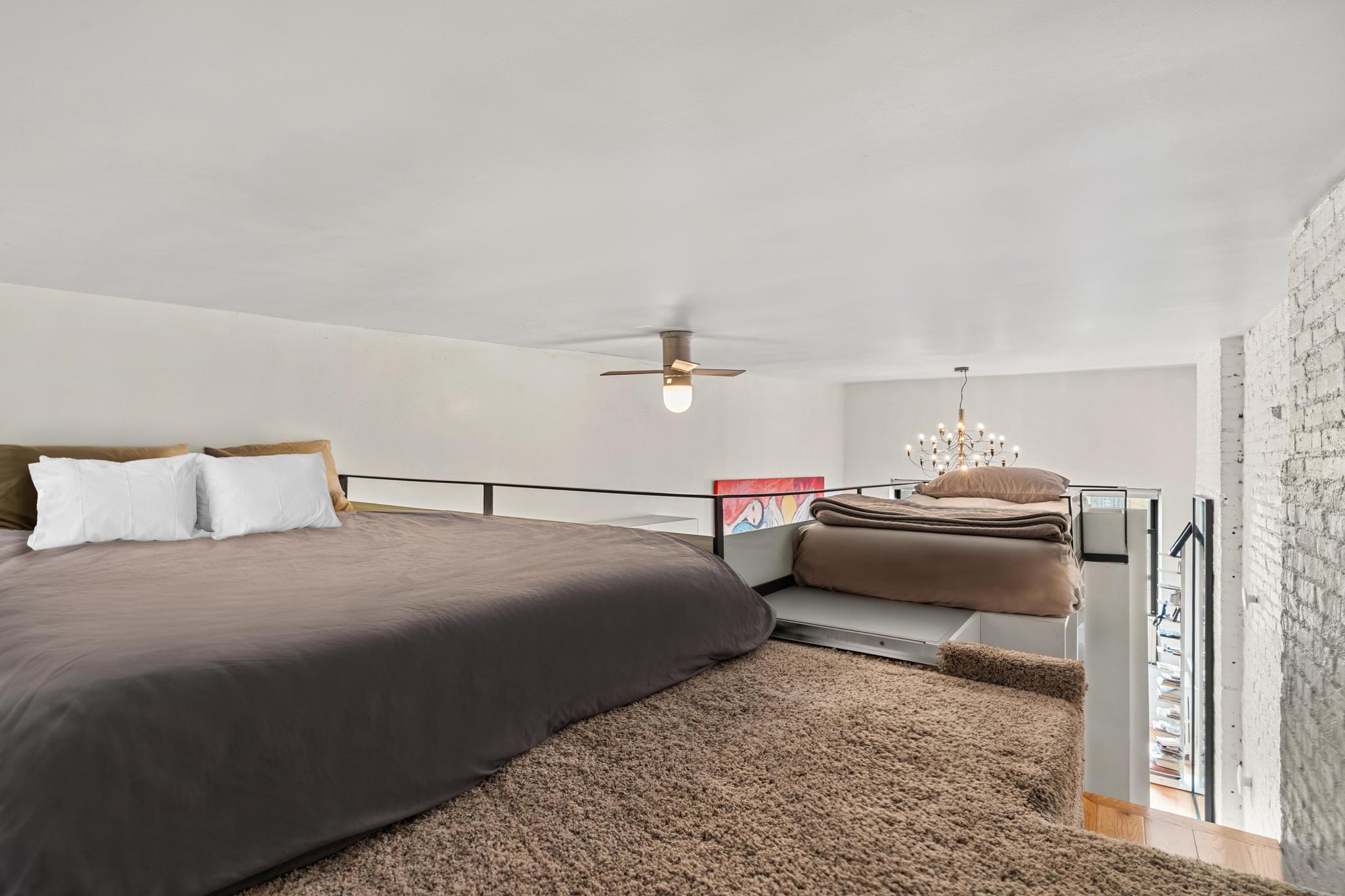 143 Sullivan Street, Unit 16 Manhattan, NY 10012 - Photo 8 of 10 a bedroom with bed and window