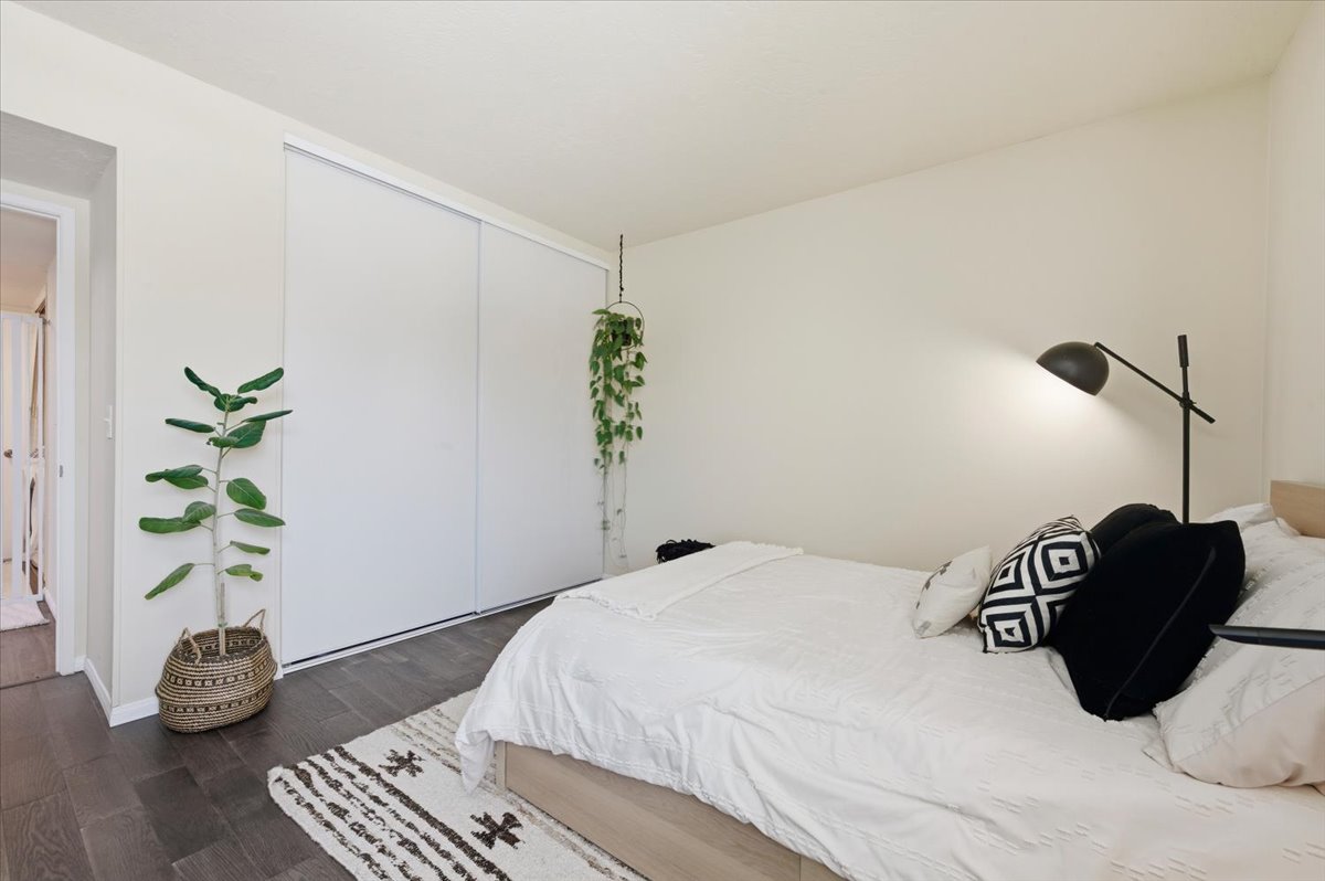 6373 Rancho Mission Road, Unit 5 San Diego, CA 92108 - Photo 20 of 30 a bedroom with a bed potted plant and a potted plant