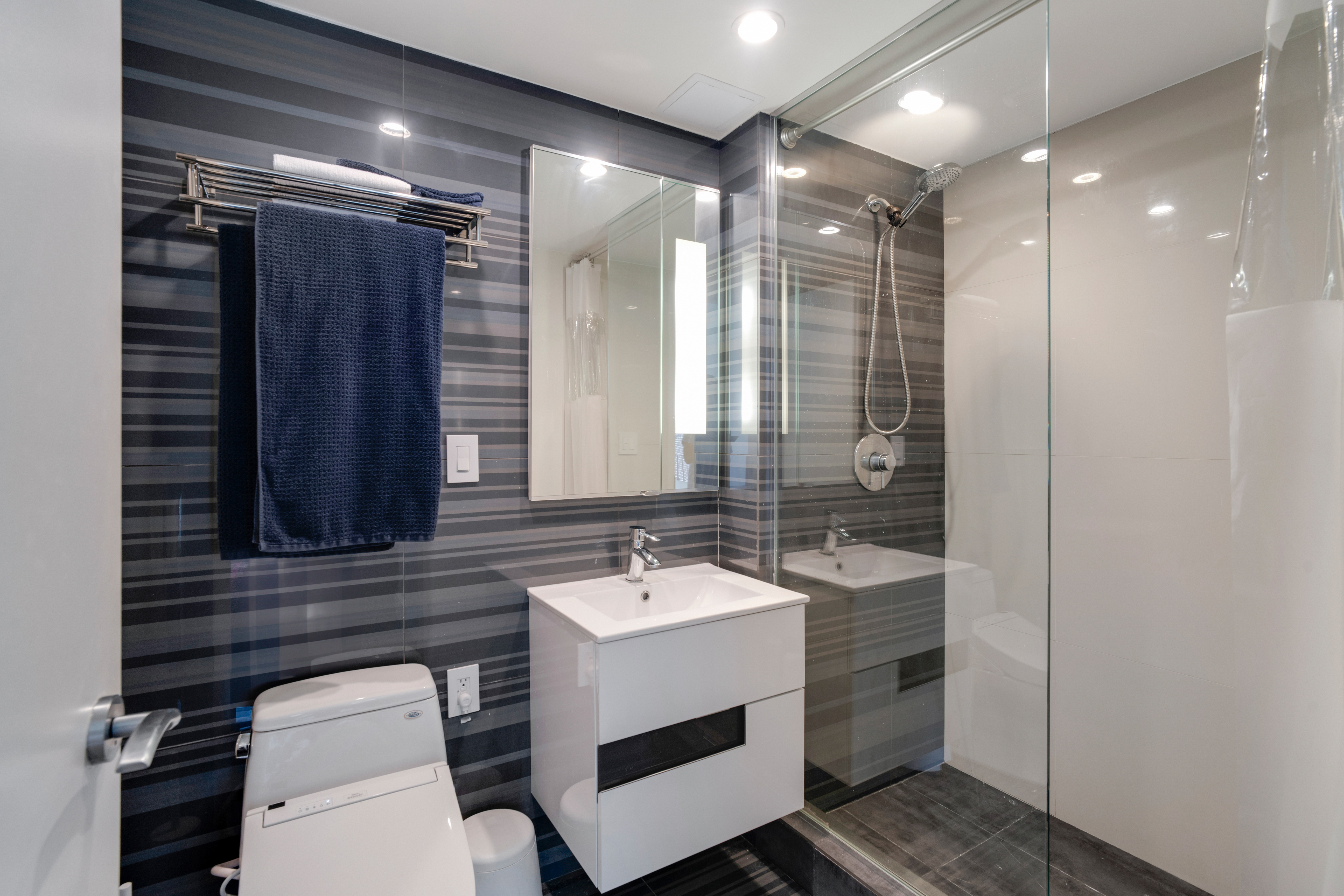 60 Orchard Street, Unit 4 Manhattan, NY 10002 - Photo 14 of 18 a bathroom with a sink a toilet a mirror and shower