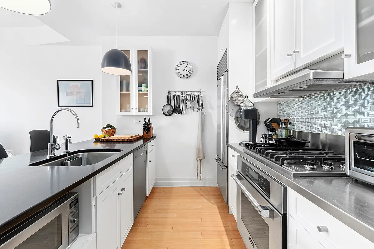 110 Livingston Street, Unit 10K Brooklyn, NY 11201 - Photo 4 of 10 a kitchen with stainless steel appliances granite countertop a sink stove and cabinets