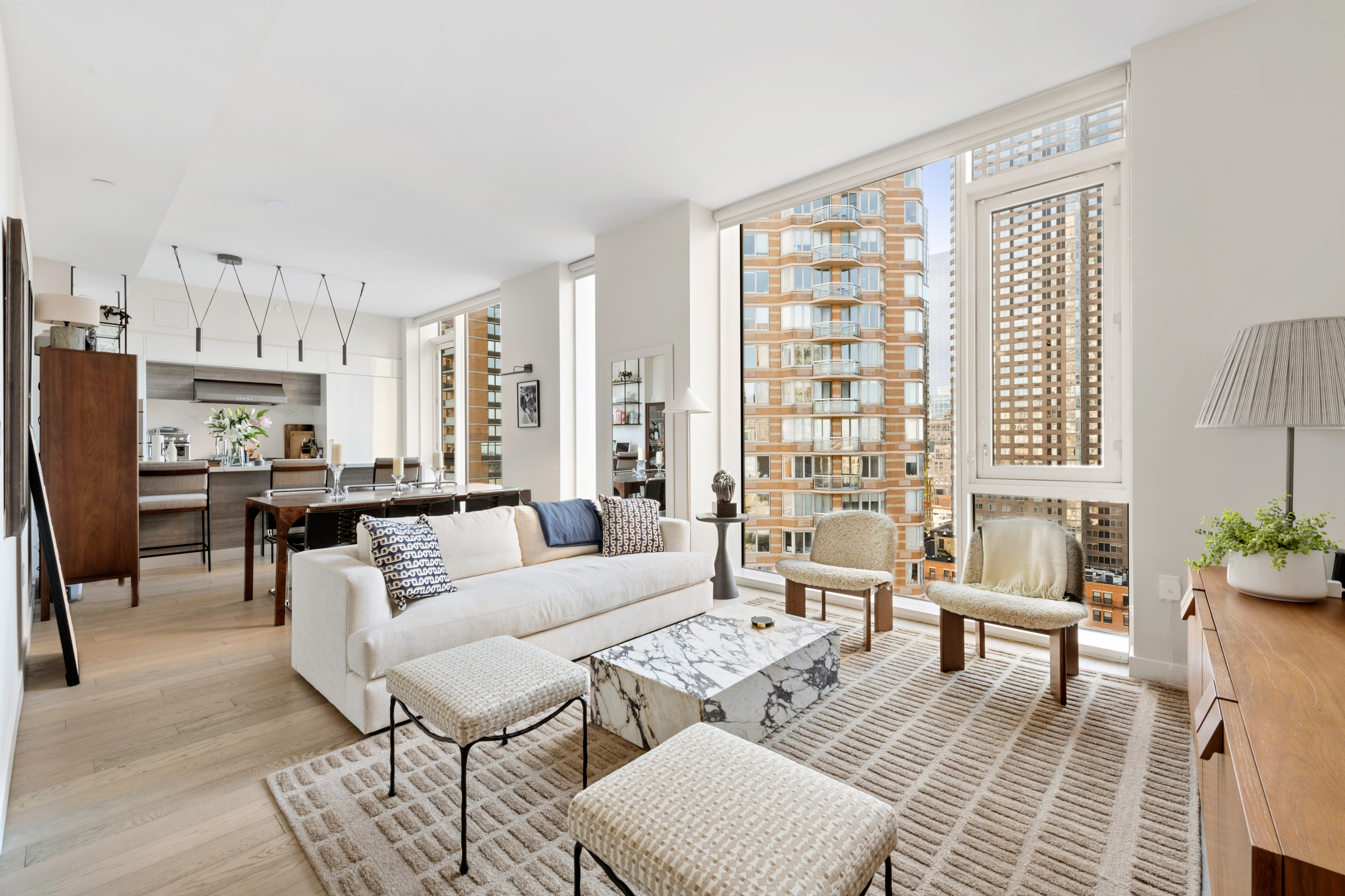 505-513 West 43rd Street, Unit PHG Manhattan, NY 10036 - Photo 2 of 20 a living room with furniture and a large window