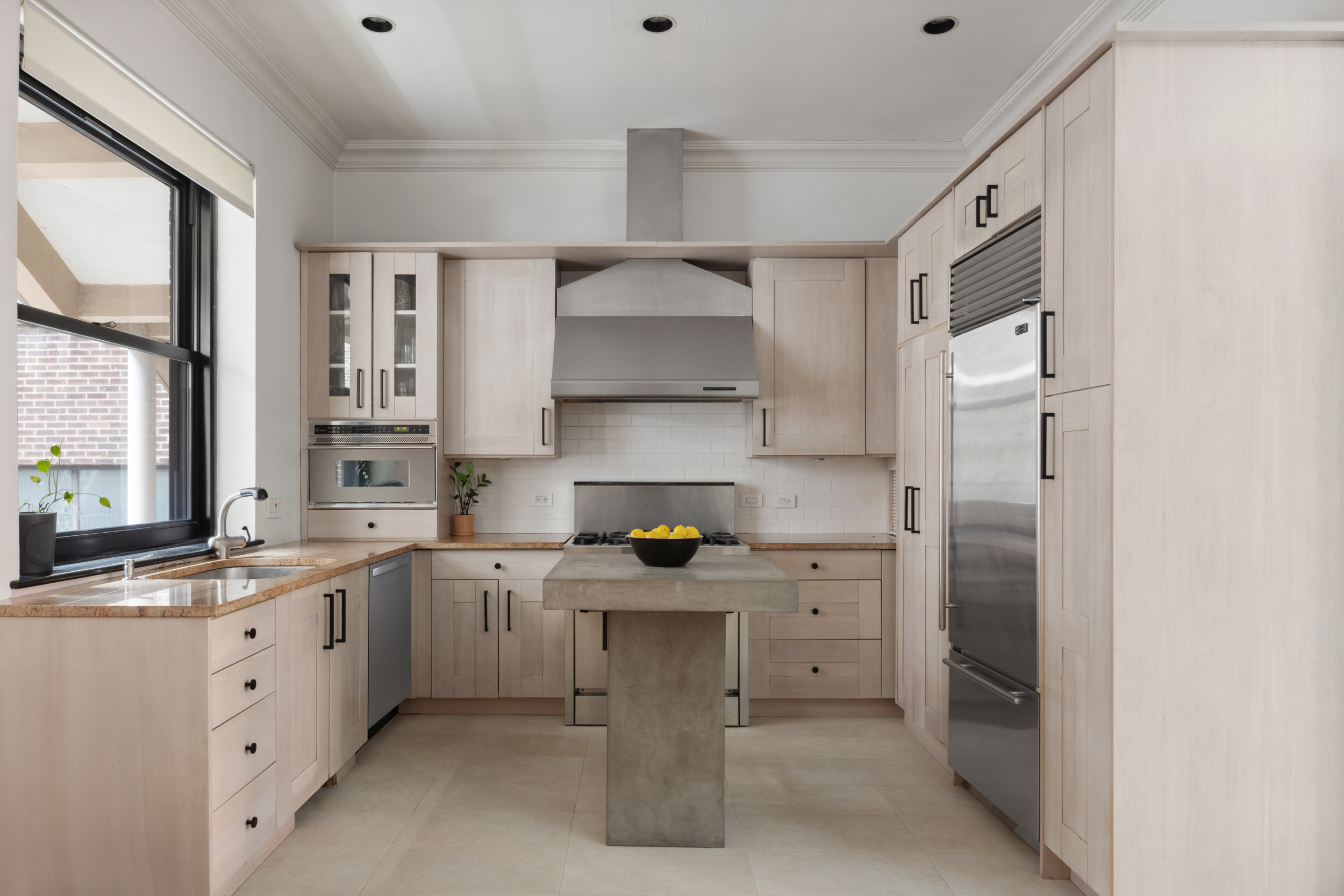 250 Mercer Street, Unit A504 Manhattan, NY 10012 - Photo 2 of 13 a kitchen with a sink stove and cabinets