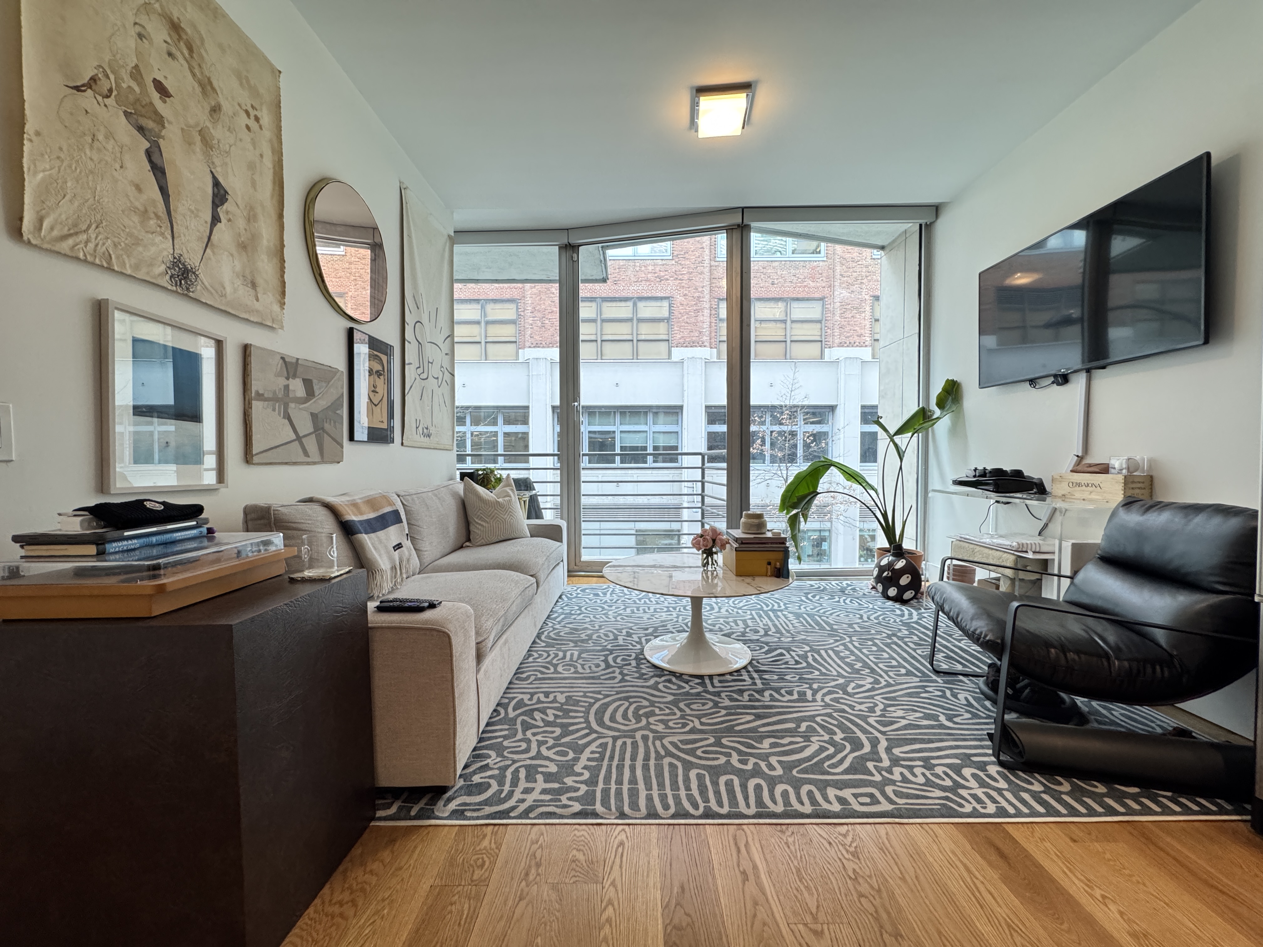 343 West 16th Street, Unit 3F Manhattan, NY 10011 - Photo 2 of 10 a living room with furniture fireplace and a flat screen tv
