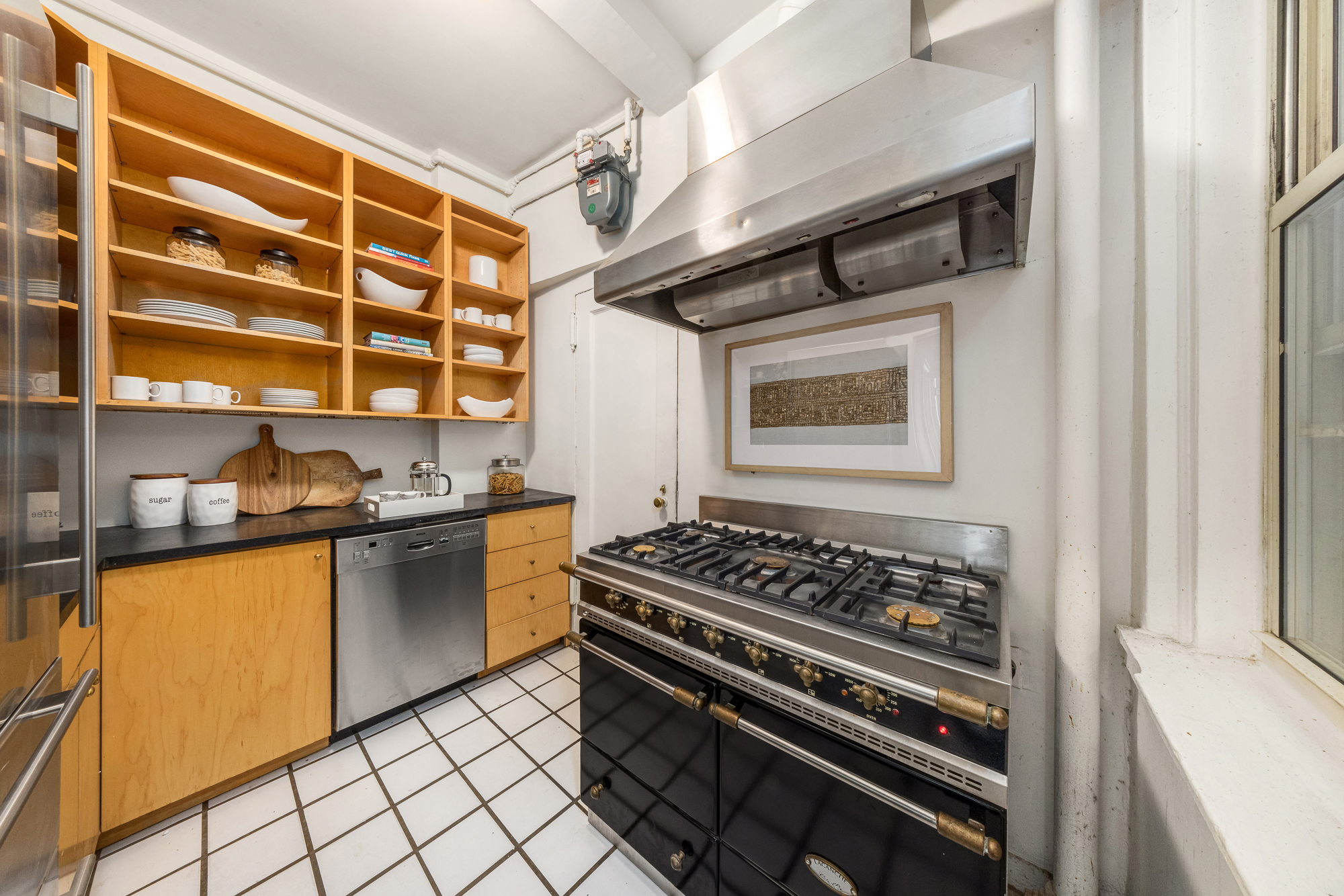 39 5th Avenue, Unit 2B Manhattan, NY 10003 - Photo 8 of 12 a kitchen with granite countertop a stove and a sink