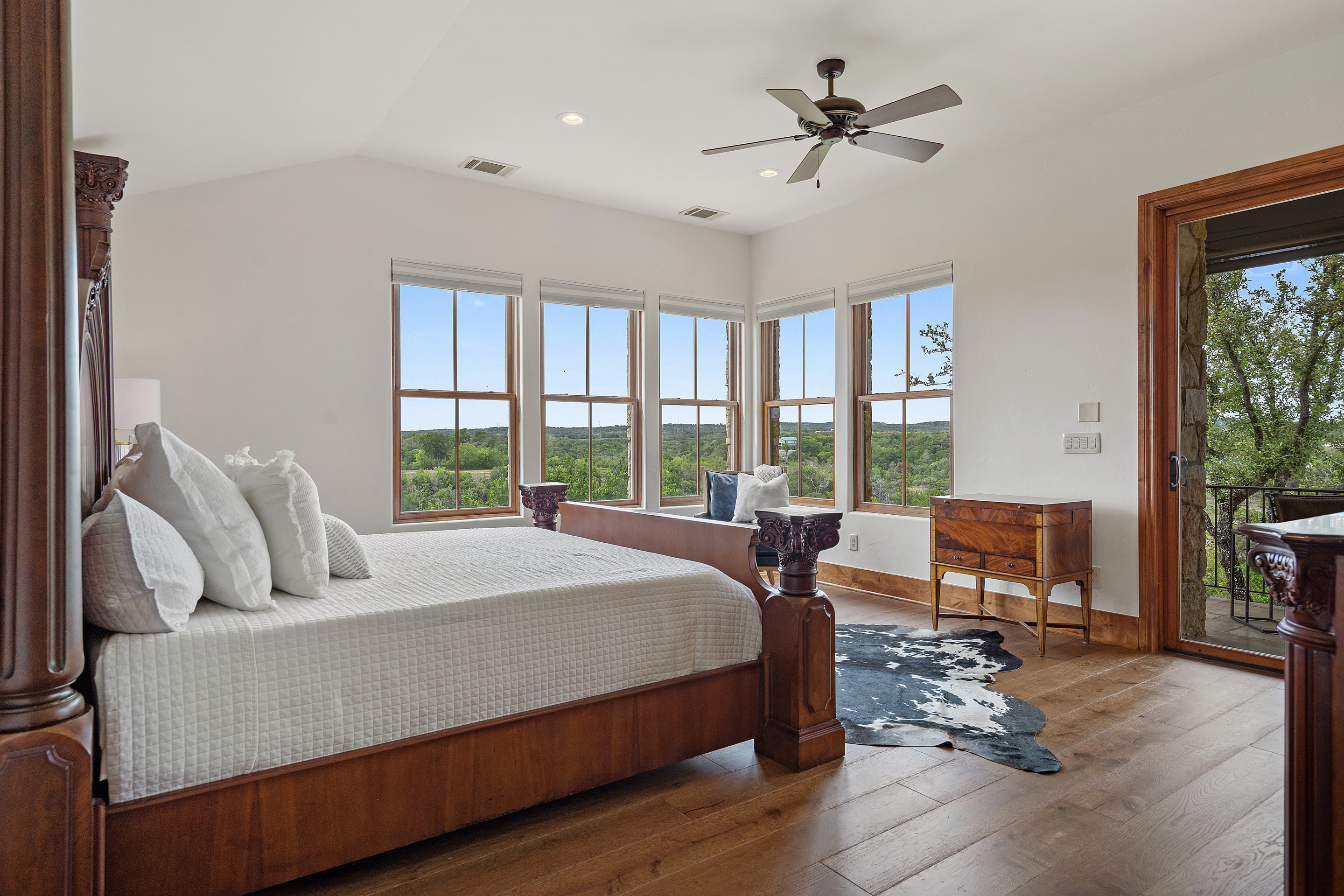 808 Rivercliff Drive Spicewood, TX 78669 - Photo 35 of 71 a bedroom with a bed and large windows