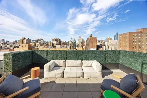 a view of a terrace with couches and pool