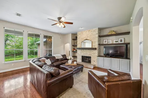 a living room with furniture a fireplace and a flat screen tv