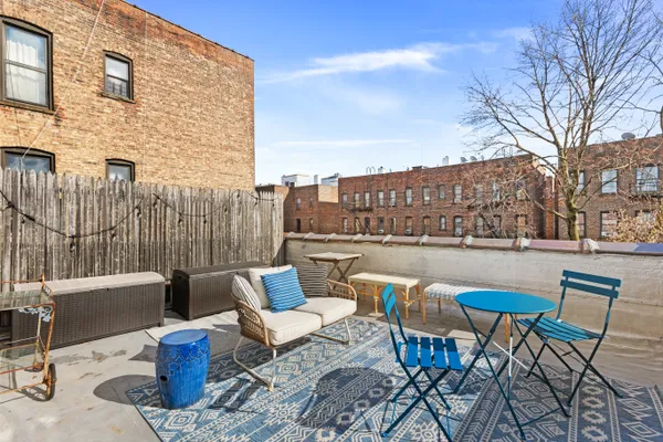 a view of a terrace with furniture and a fire pit
