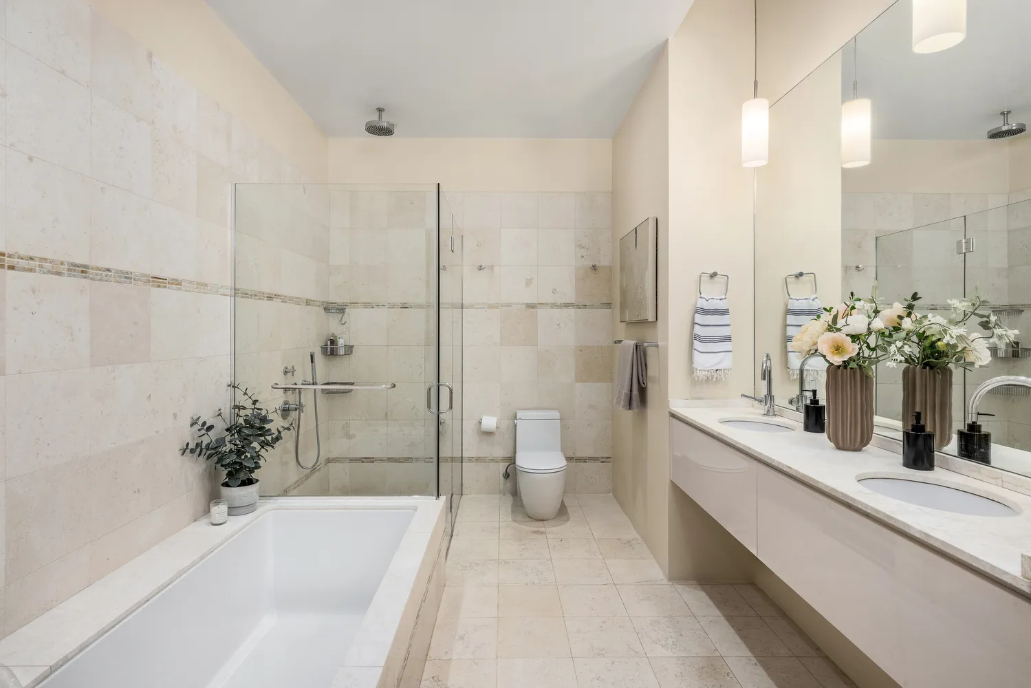 a bath room with a toilet a sink and a bath tub
