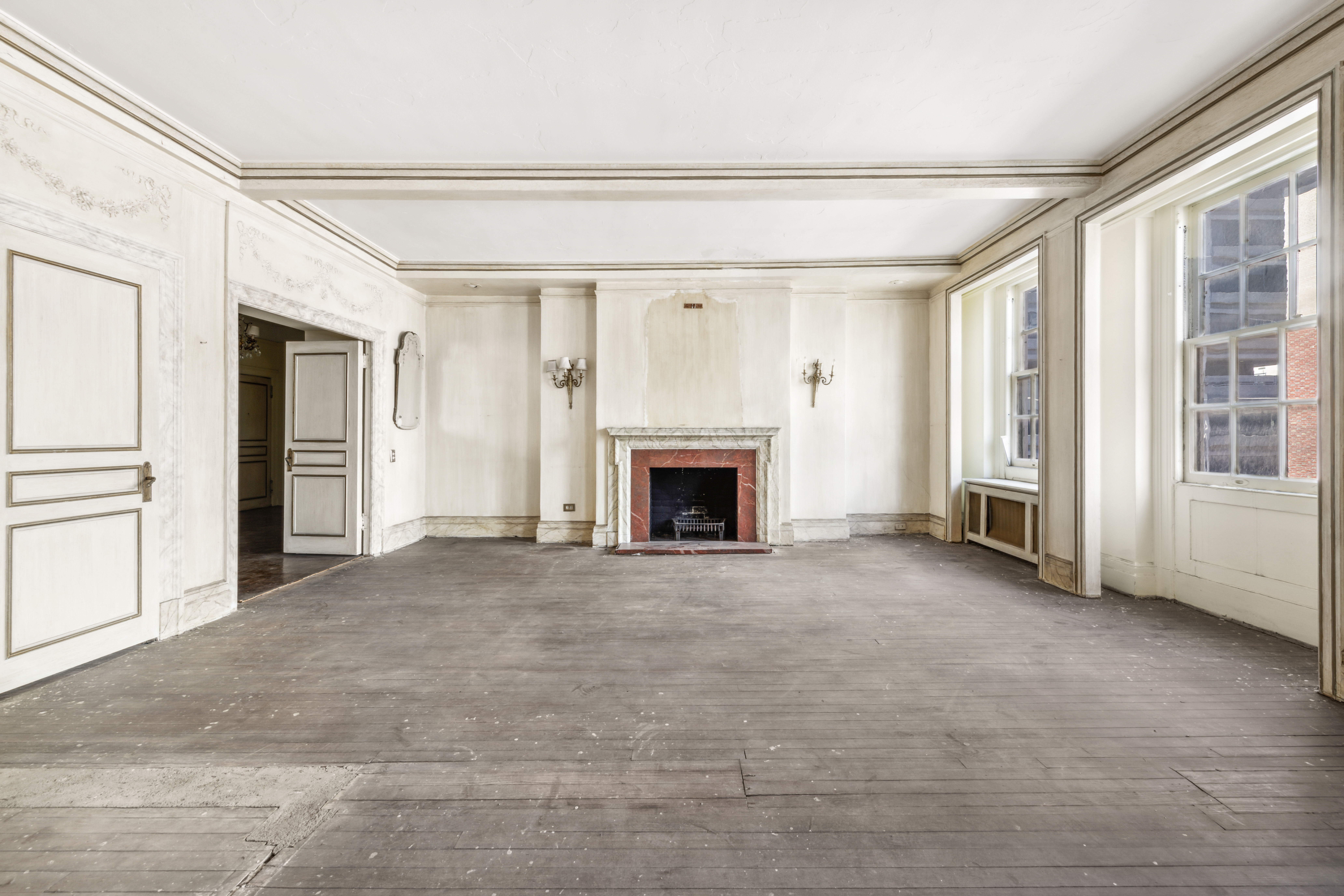 130 East 67th Street, Unit 9C Manhattan, NY 10065 - Photo 2 of 20 a view of an empty room with a fireplace and a window
