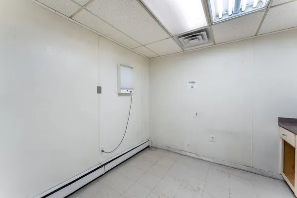 a kitchen with white cabinets and white appliances
