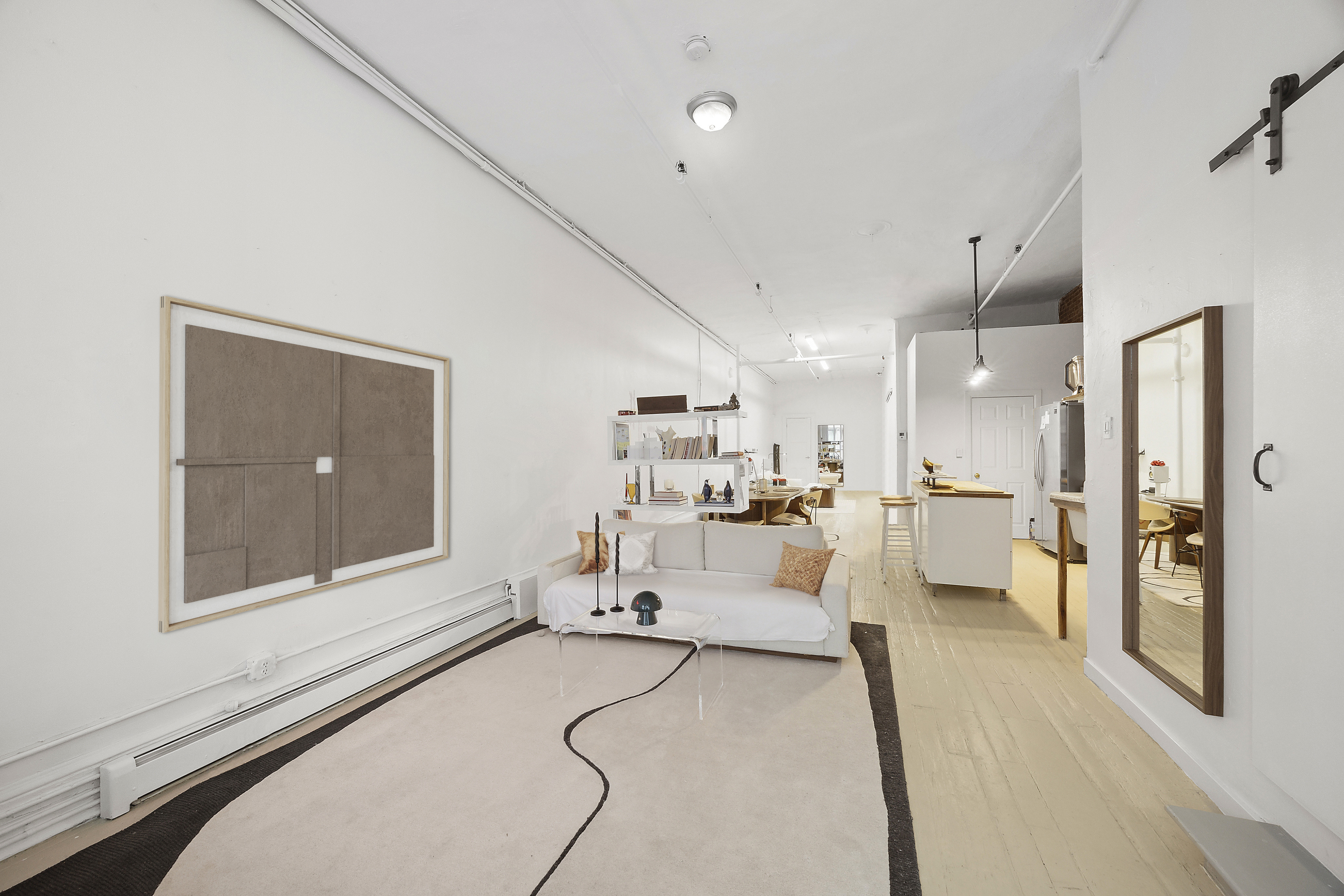 8 Greene Street, Unit 3 Manhattan, NY 10013 - Photo 2 of 7 a living room with furniture and a large window