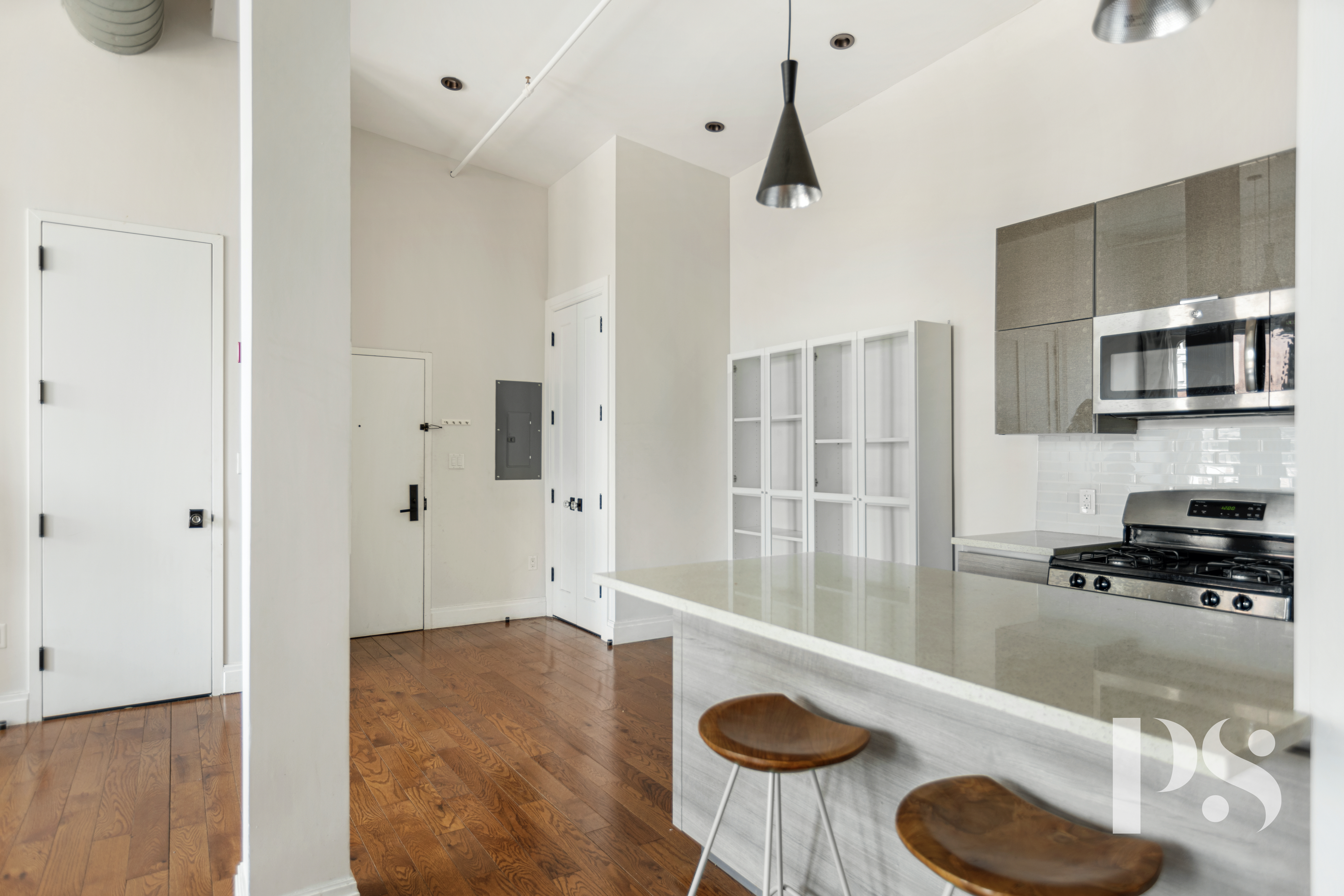 2 Wooster Street, Unit 5A Manhattan, NY 10013 - Photo 4 of 12 a kitchen with granite countertop a sink a stove and a refrigerator