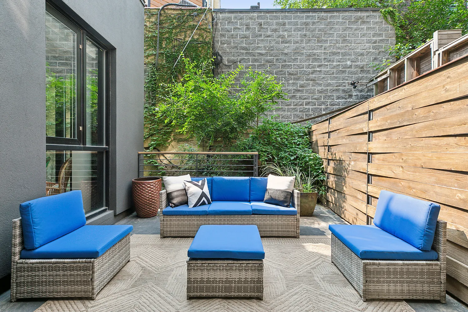 a outdoor space with patio couch and a potted plant