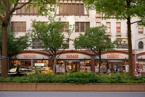 a view of a park with bench and trees