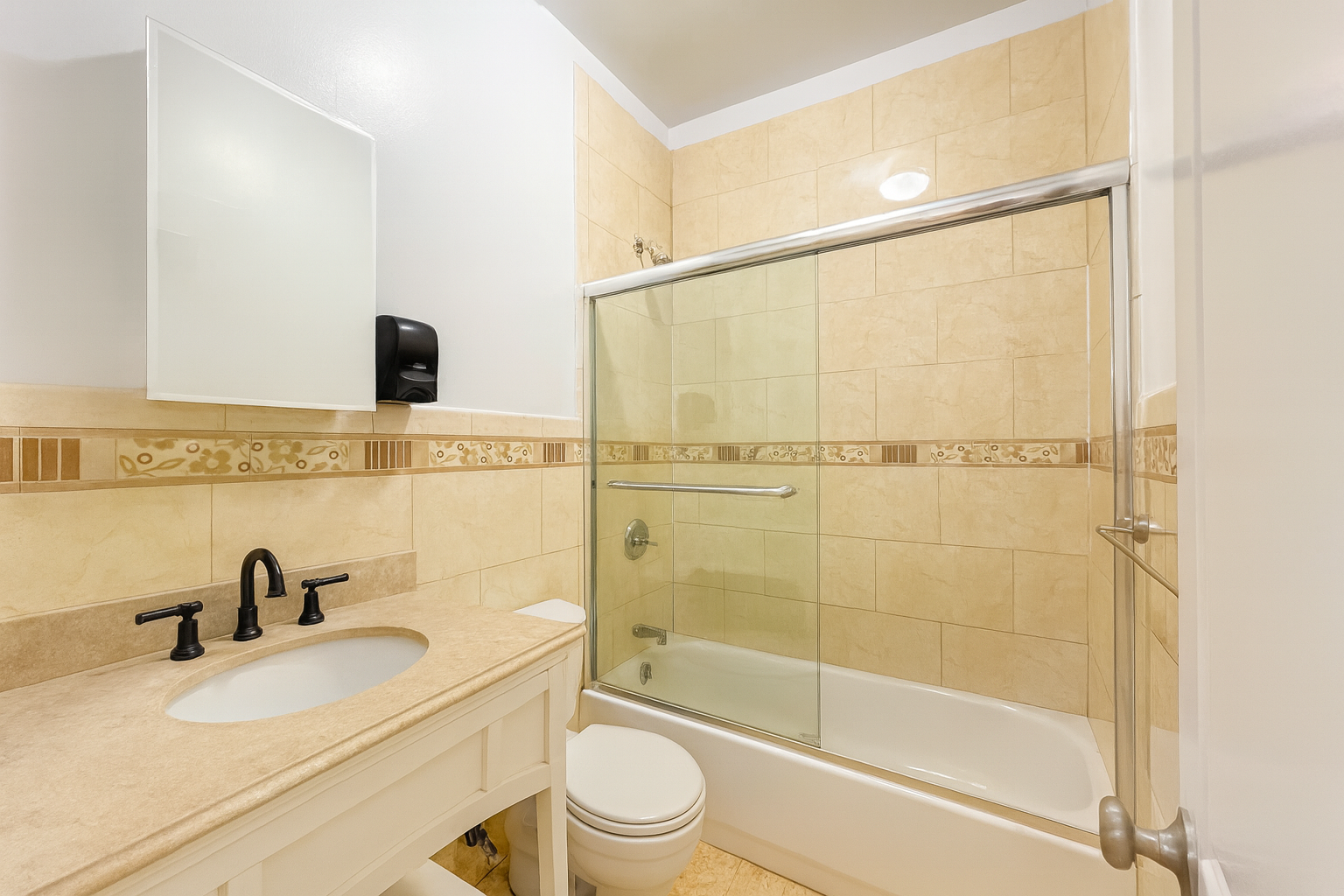 37-15 Broadway, Unit 3 Queens, NY 11103 - Photo 8 of 9 a bathroom with a granite countertop sink a toilet and shower