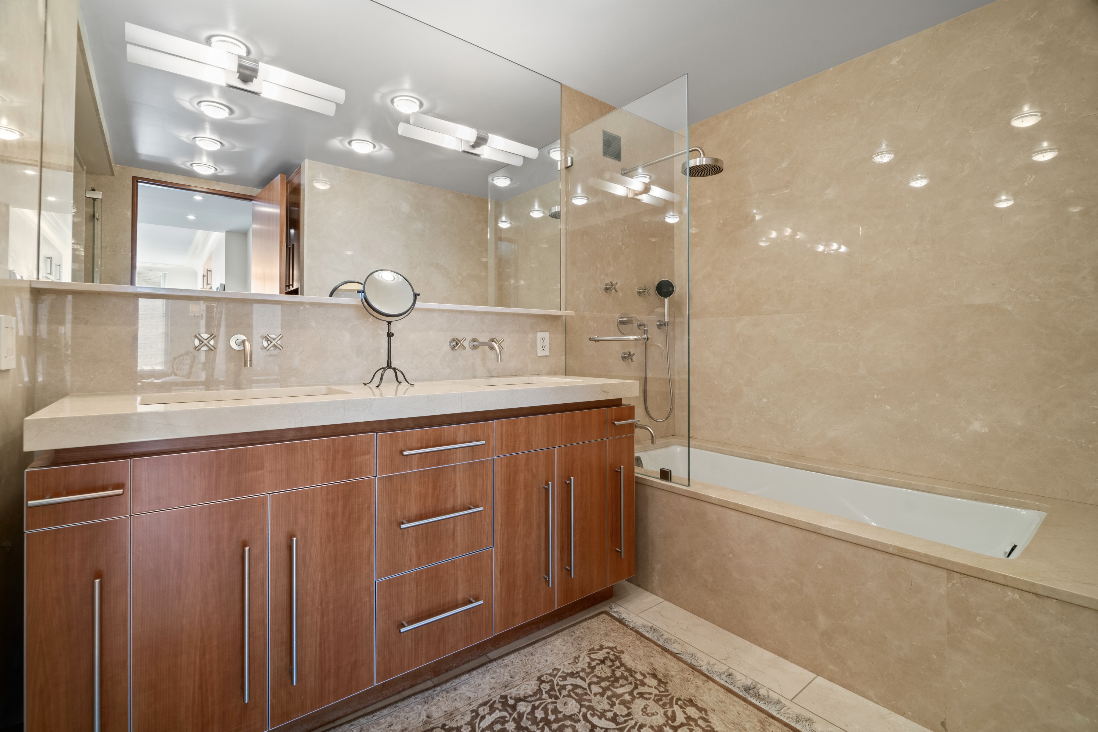 279 Central Park West, Unit 11B Manhattan, NY 10024 - Photo 12 of 24 a bathroom with a double vanity sink a toilet a mirror and shower