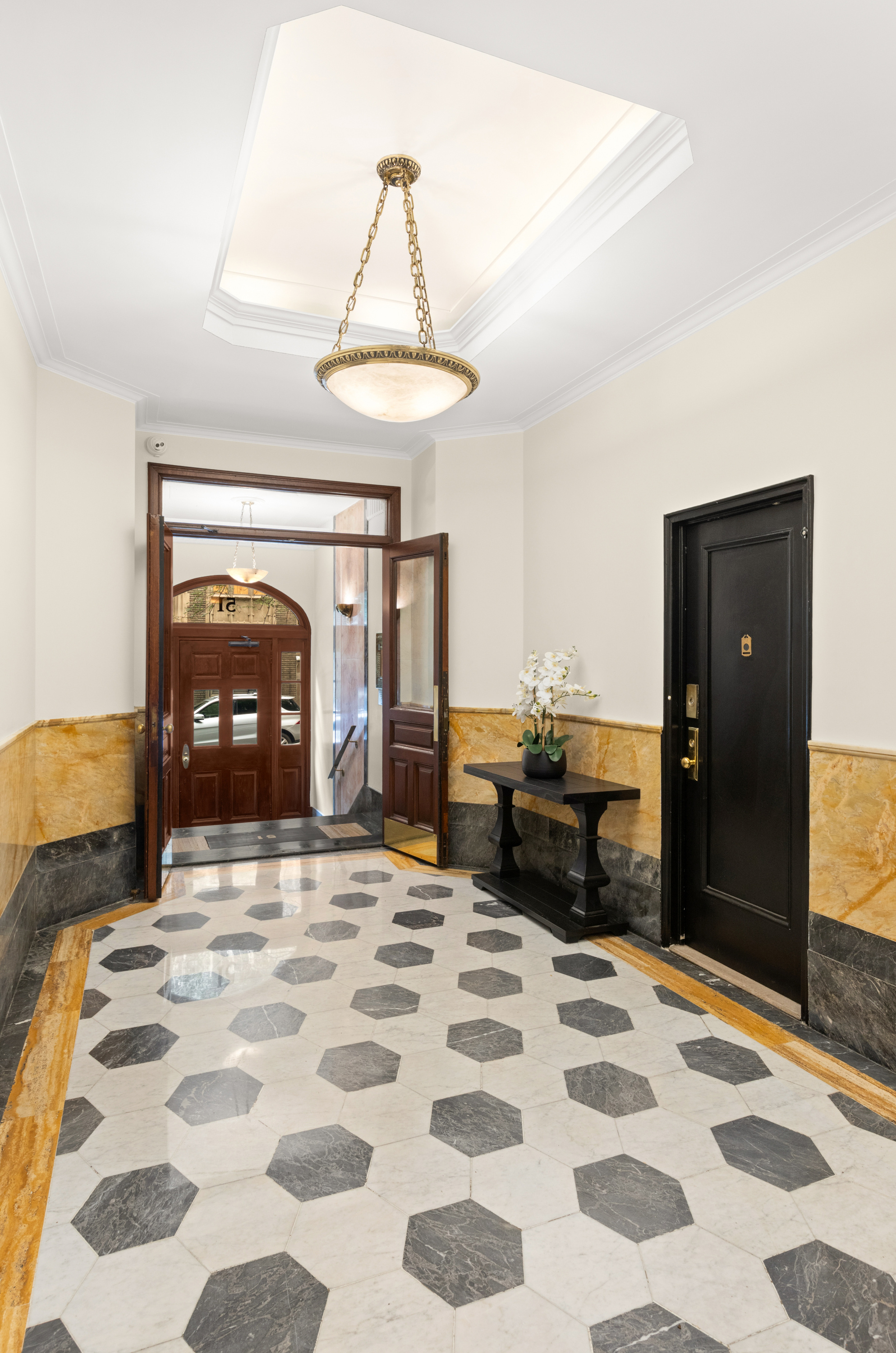 51 East 78th Street, Unit 3BC Manhattan, NY 10075 - Photo 23 of 25 a bedroom with a bed and a mirror on dresser