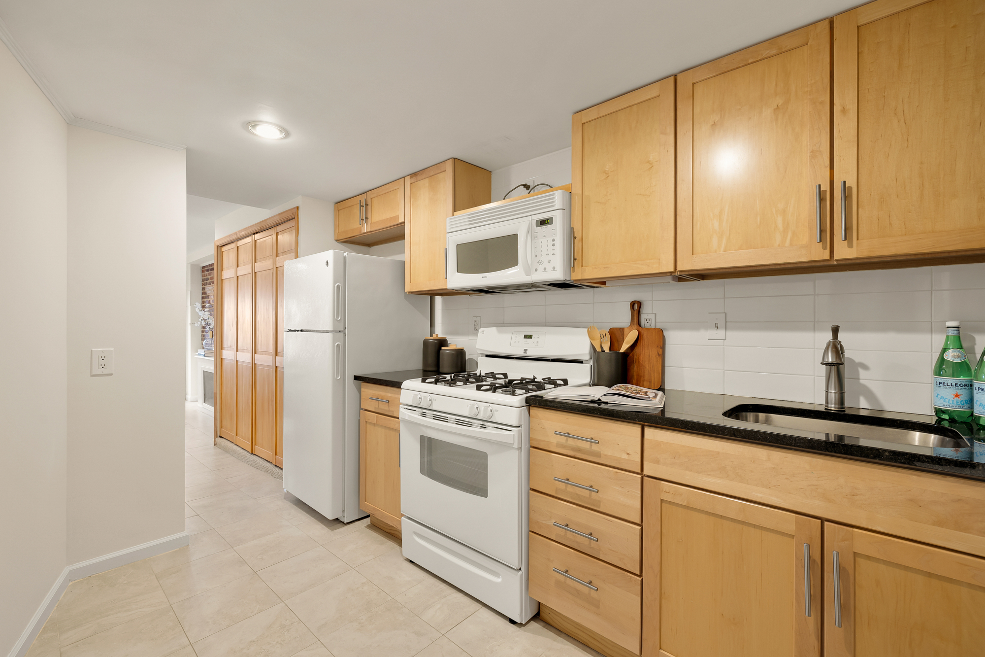 903 F Street Northeast Washington, DC 20002 - Photo 37 of 41 a kitchen with stainless steel appliances granite countertop a stove a sink and a refrigerator