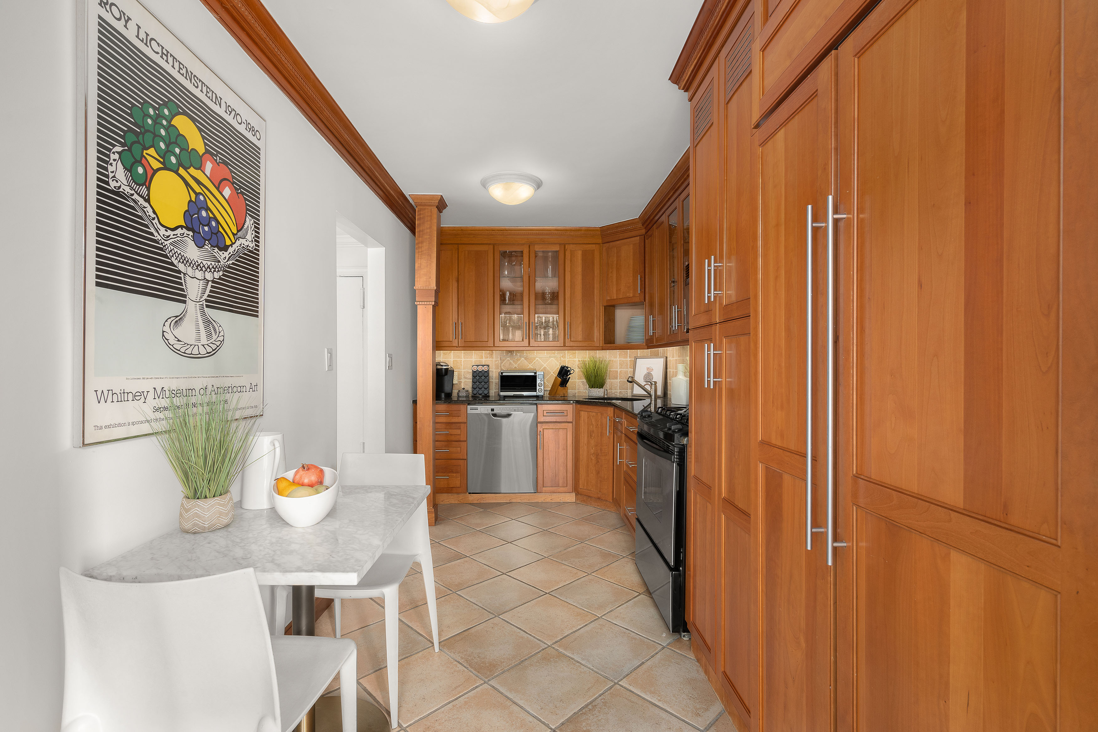 207 East 74th Street, Unit 11E Manhattan, NY 10021 - Photo 7 of 20 a kitchen with stainless steel appliances granite countertop a refrigerator and a sink