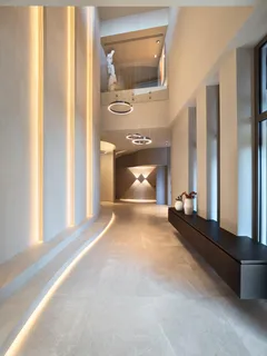 a living room with a fireplace furniture a flat screen tv and a window