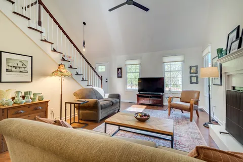 a view of a livingroom with furniture wooden floor and a window