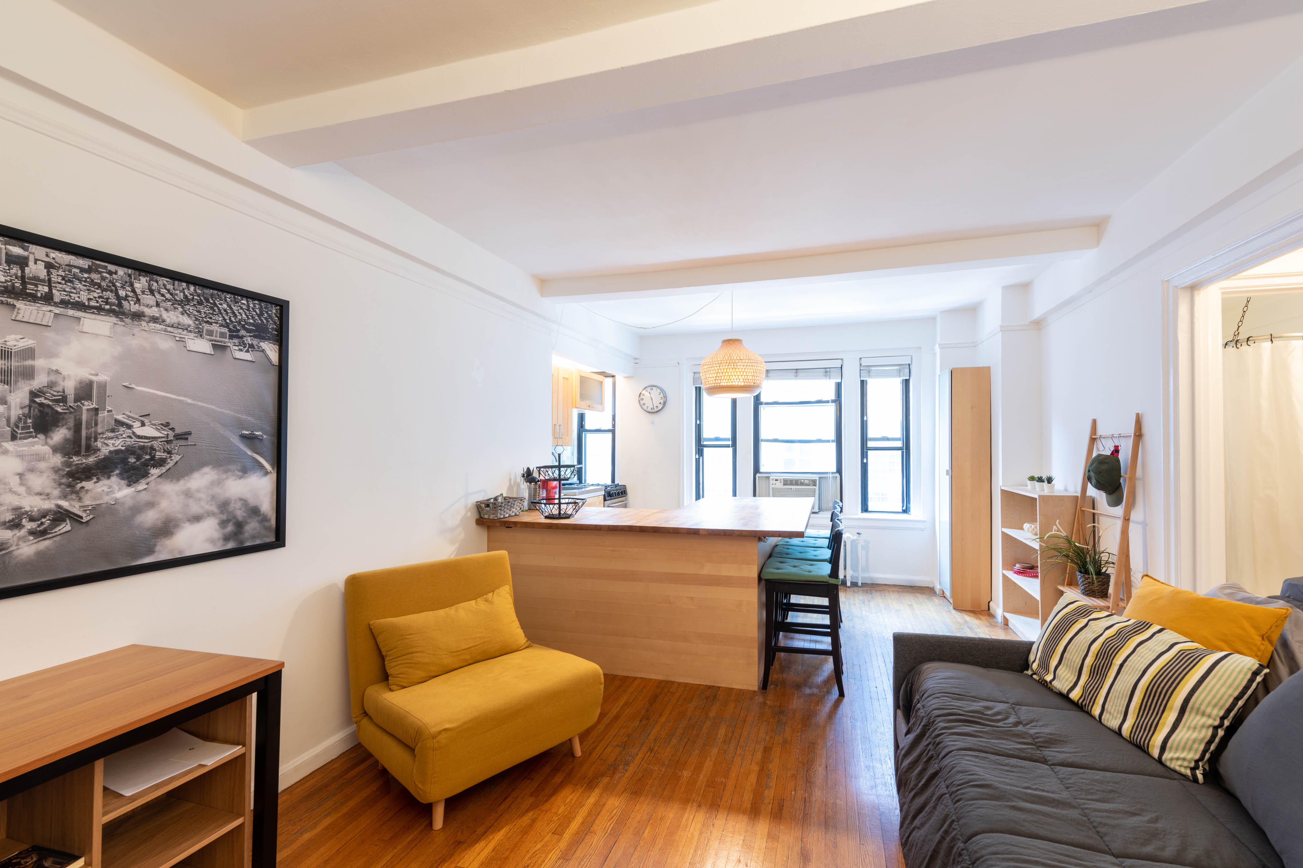 339 East 58th Street, Unit 5B Manhattan, NY 10022 - Photo 5 of 13 a living room with furniture and a large window
