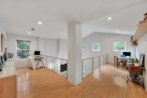 a view of a porch with furniture and wooden floor
