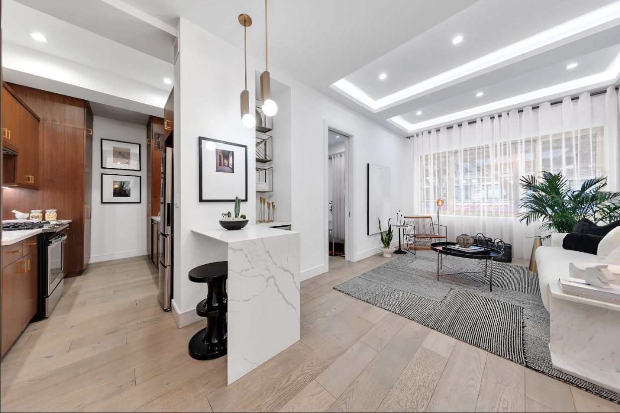 a living room with furniture and wooden floor