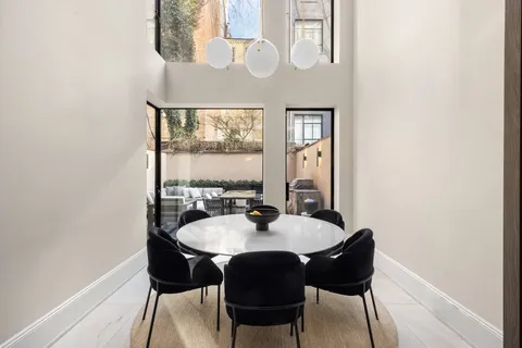 a view of a dining room with furniture and window