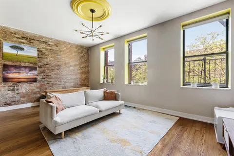 a living room with couch and a large window